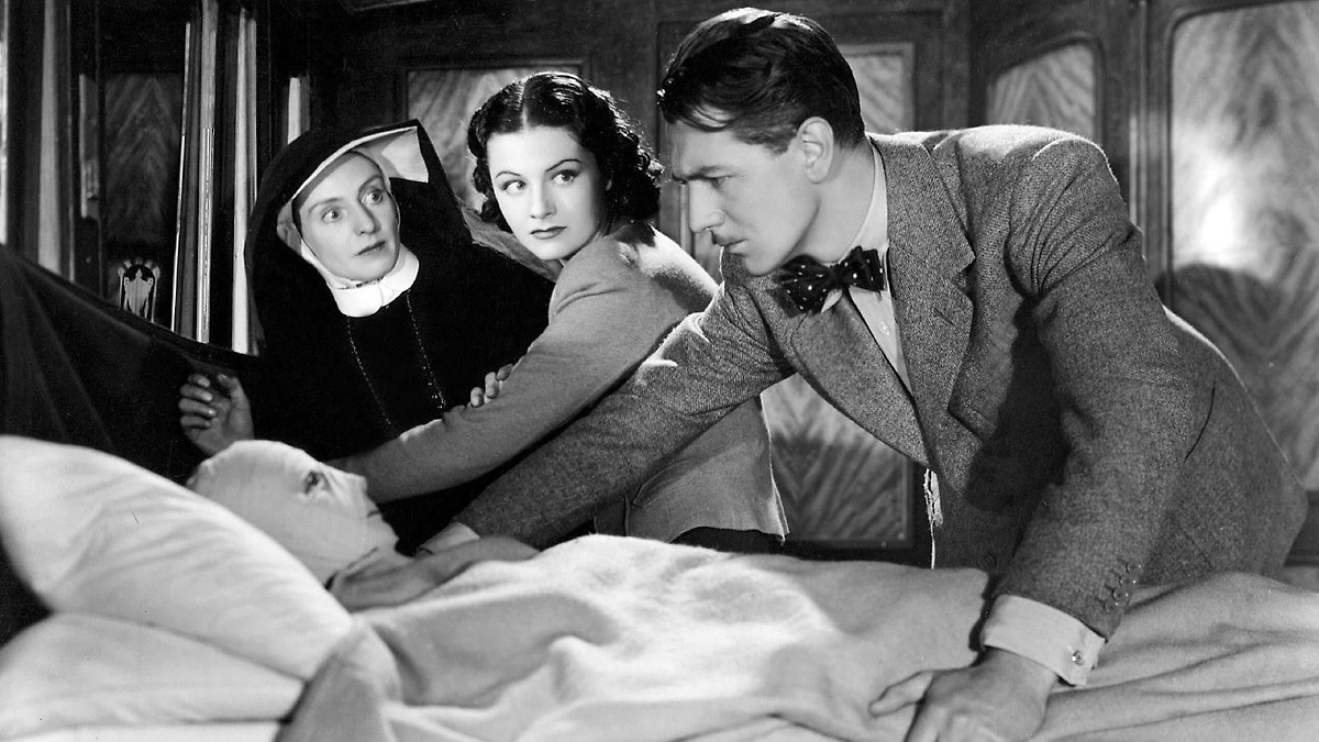 A screenshot of The Lady Vanishes, with the two protagonists, the nun and the man with a mask of bendages.