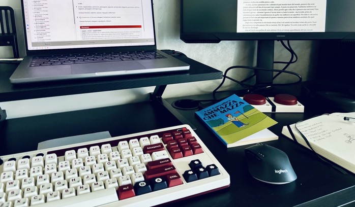 A desk with two monitors, a laptop, and a 8bitdo retro keyboard.
