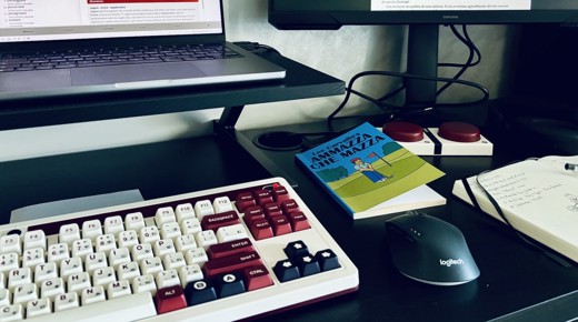 A desk with two monitors, a laptop, and a 8bitdo retro keyboard.