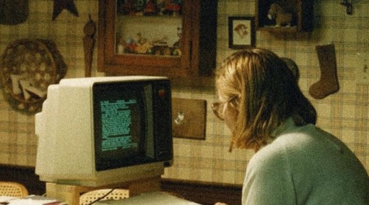 A person in front of a 80s computer.